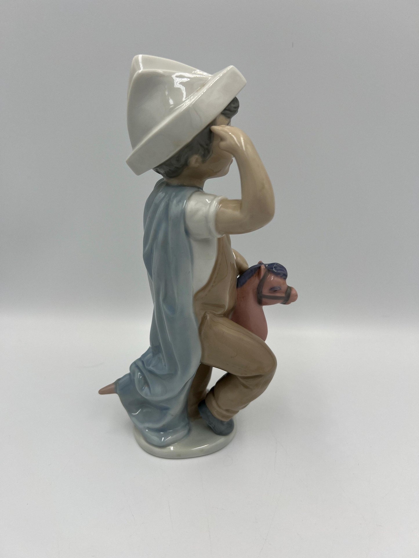 Boy on Hobby Horse Figurine: Lladro Little Conquistador - Porcelain Sculpture