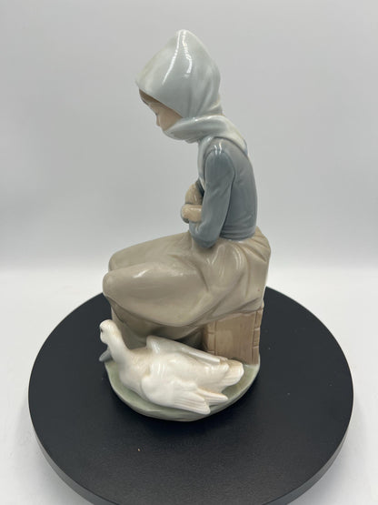 Lladro Statues, "Girl Gathering Flowers" and "Duck Seller" Lladro Porcelain Sculpture - Sold Individually
