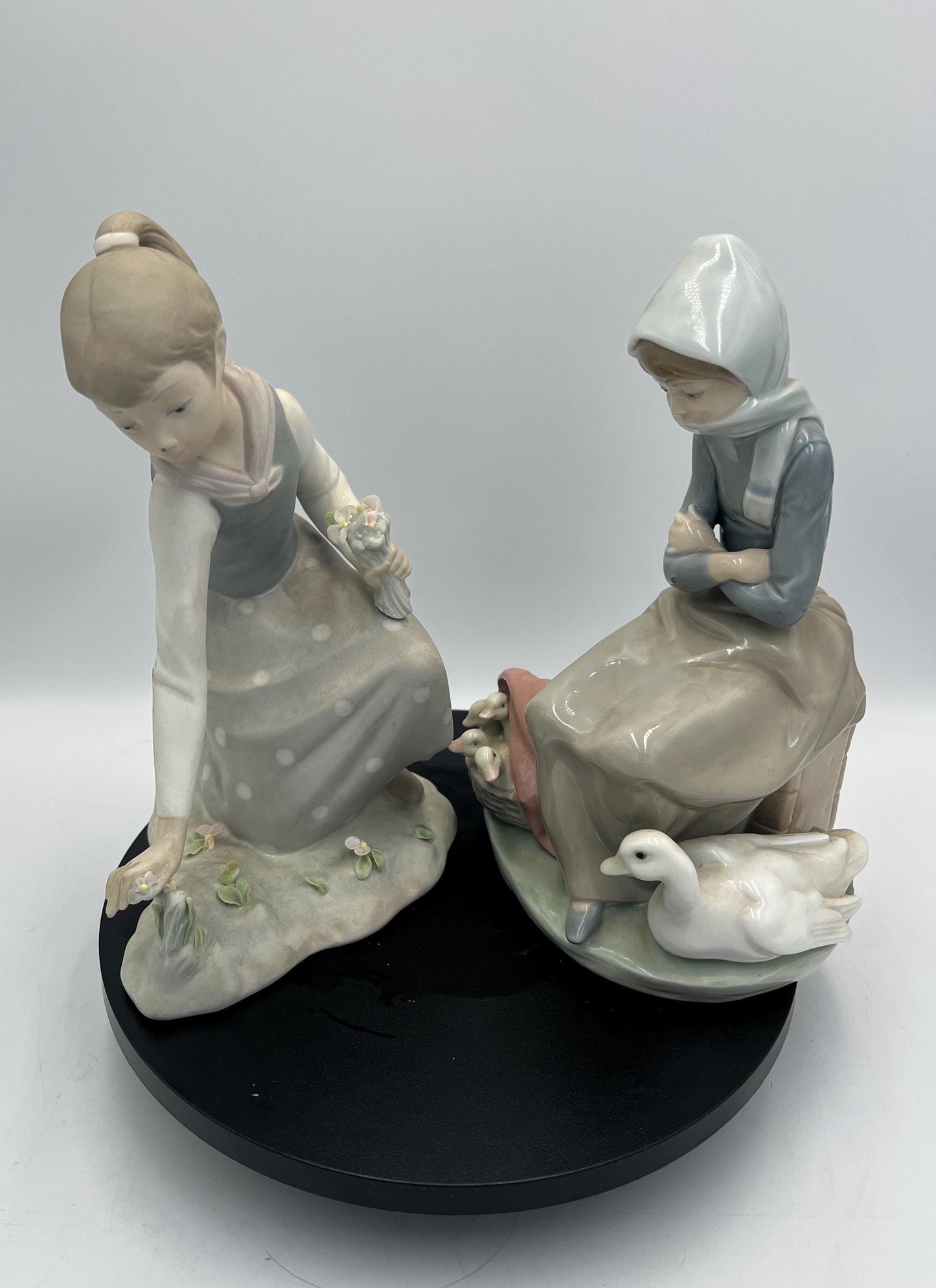 Lladro Statues, "Girl Gathering Flowers" and "Duck Seller" Lladro Porcelain Sculpture - Sold Individually